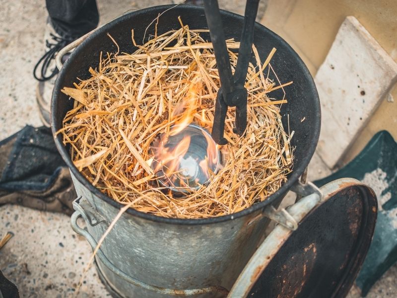 firing pottery in wood shavings